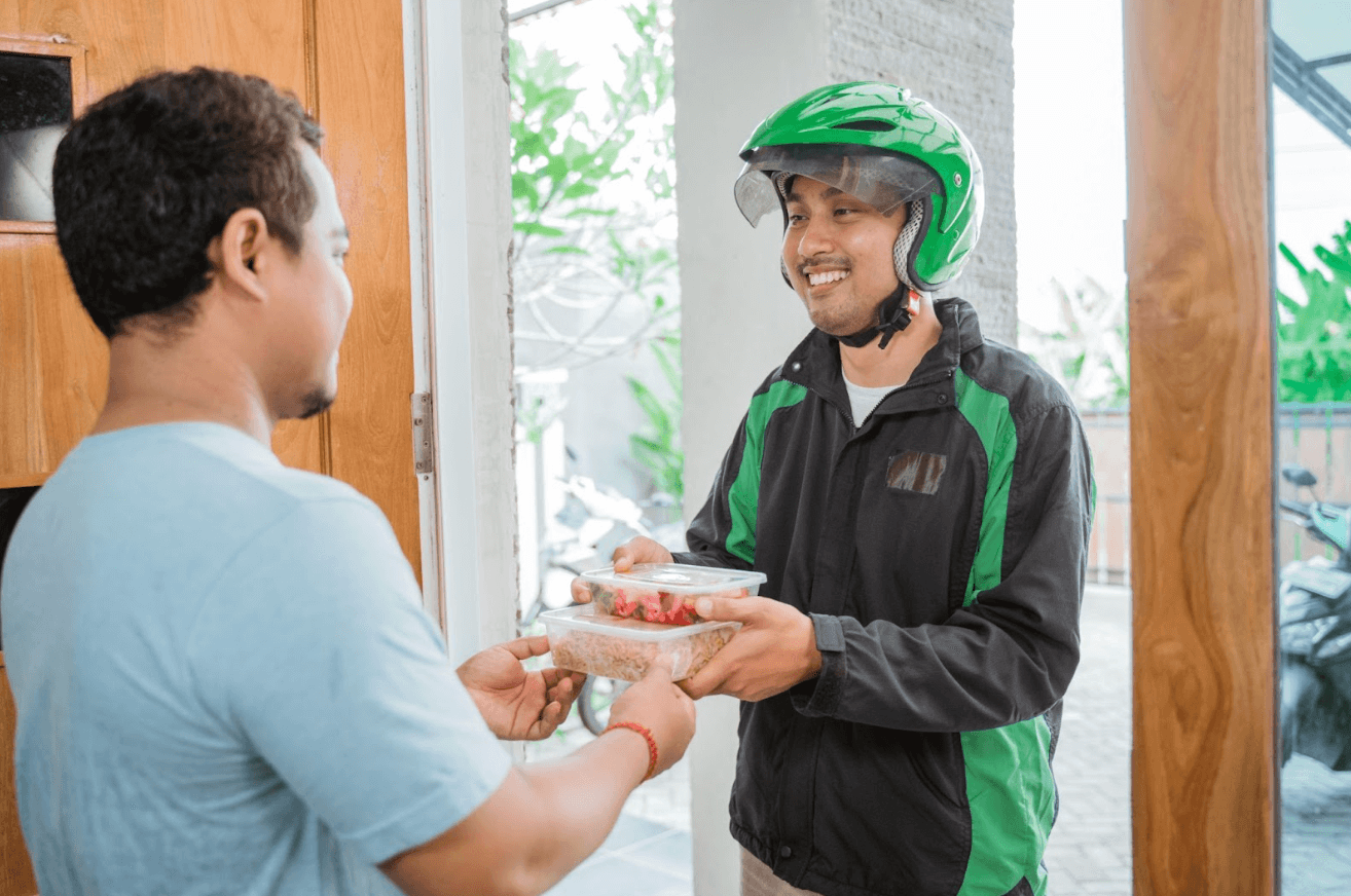 delivery driver delivering food with a smile